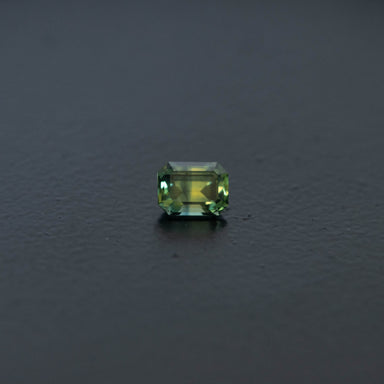 Green gemstone on a dark gray background