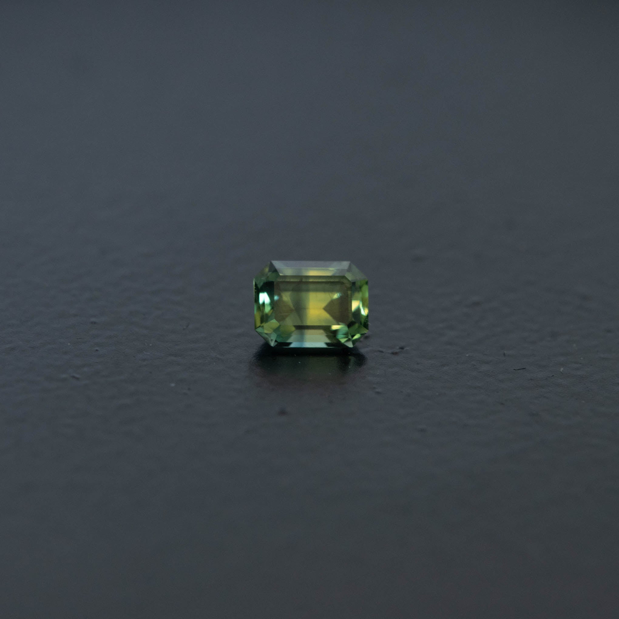 Green gemstone on a dark gray background