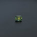 Green gemstone on a dark gray background
